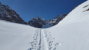 Skispuren im Schnee auf einem Berg